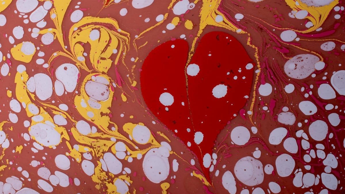 Intricate marbled pattern featuring a bold red heart, perfect for romantic or decorative themes.