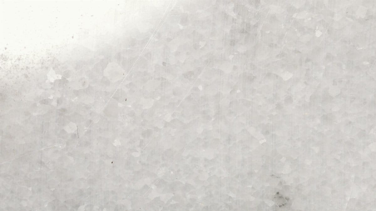 A detailed close-up of white marble surface showcasing texture and patterns.