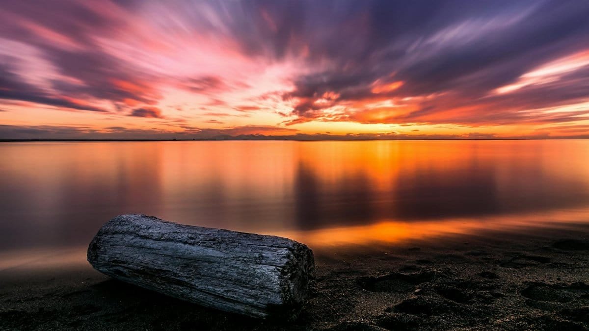 Beautiful sunset at Richmond beach with colorful sky and reflections over calm waters.