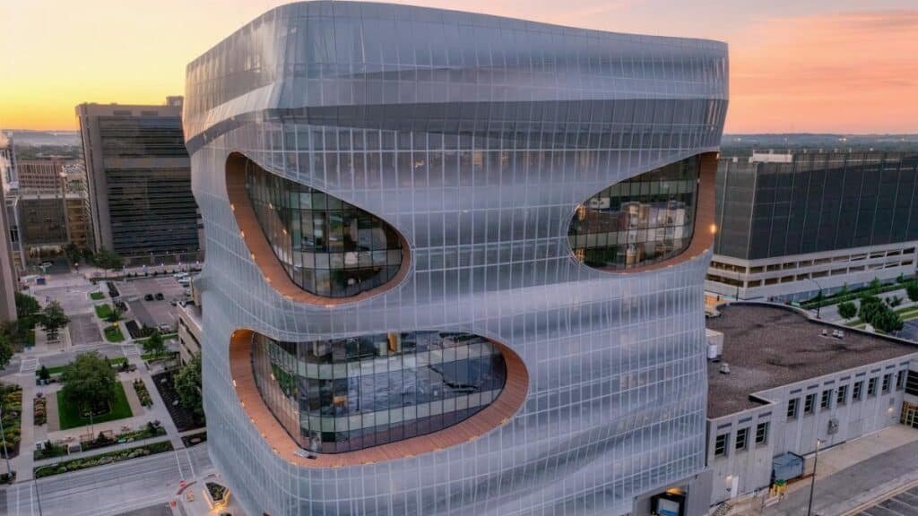 Aerial view of a modern, futuristic building in downtown Rochester, MN at sunset.