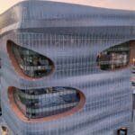 Aerial view of a modern, futuristic building in downtown Rochester, MN at sunset.