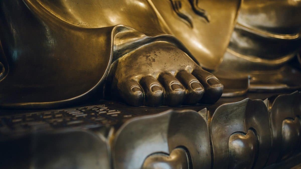Detailed close-up of a golden Buddha statue's foot, highlighting intricate design and craftsmanship in Shanghai.