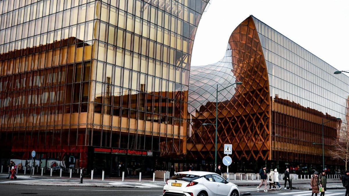 Stunning modern architecture in Malmö, showcasing glass reflections in a vibrant urban setting.