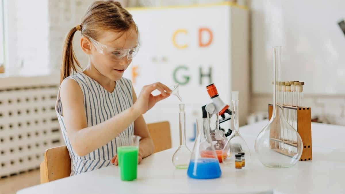 A girl performing science experiments with lab equipment, showcasing learning and curiosity.