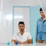 Researchers in a modern lab setting with flasks and beakers, showcasing scientific exploration.