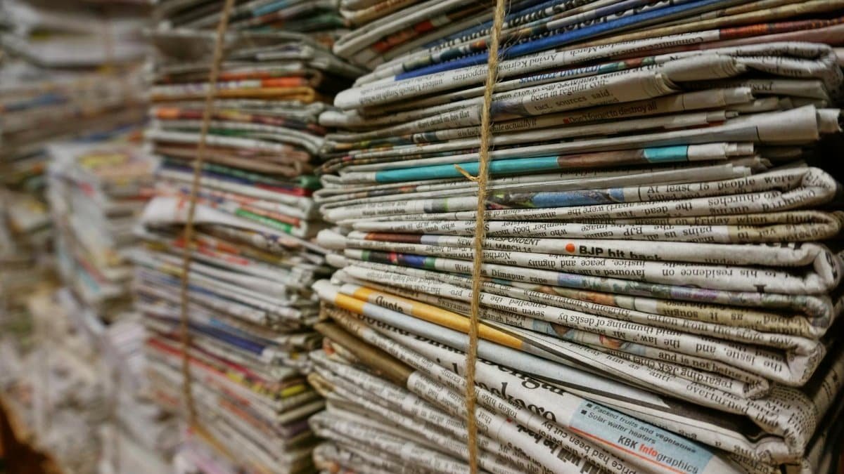 Close-up view of stacked newspapers tied with twine, ideal for recycling and storage concepts.