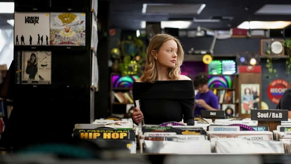 A young woman browsing records in a vibrant Los Angeles music store.