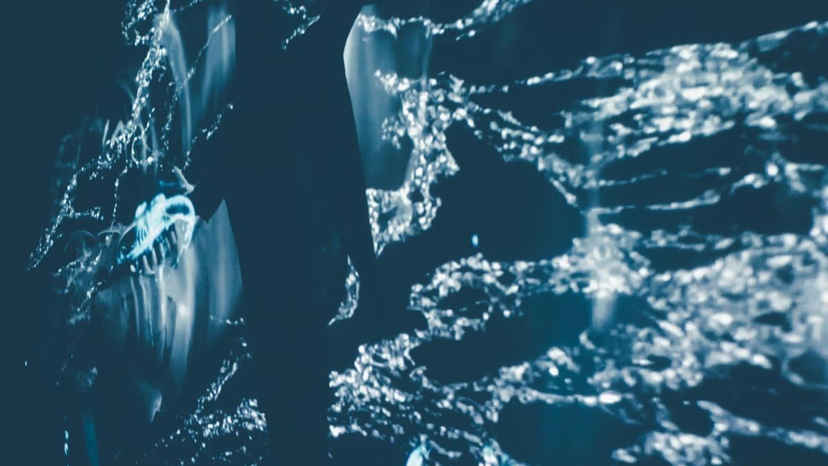 Creative abstract water splash with light effects viewed from above.