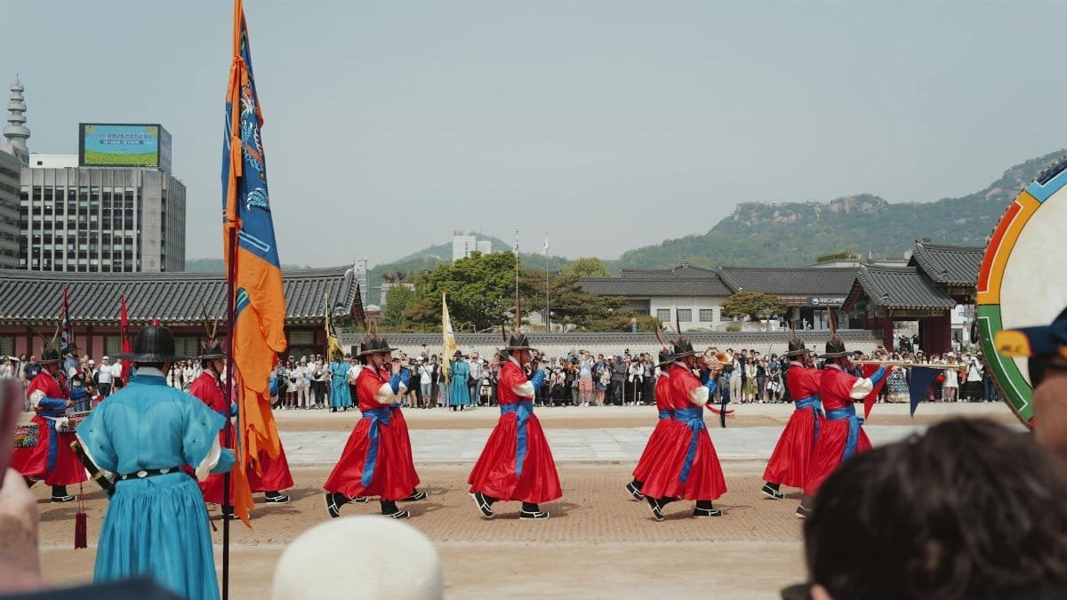 Vibrant traditional guard ceremony at a palace in Seoul, South Korea, showcasing cultural heritage.