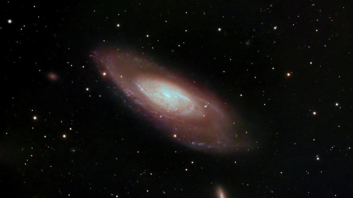 A captivating image of a spiral galaxy surrounded by stars in deep space, showcasing cosmic beauty.