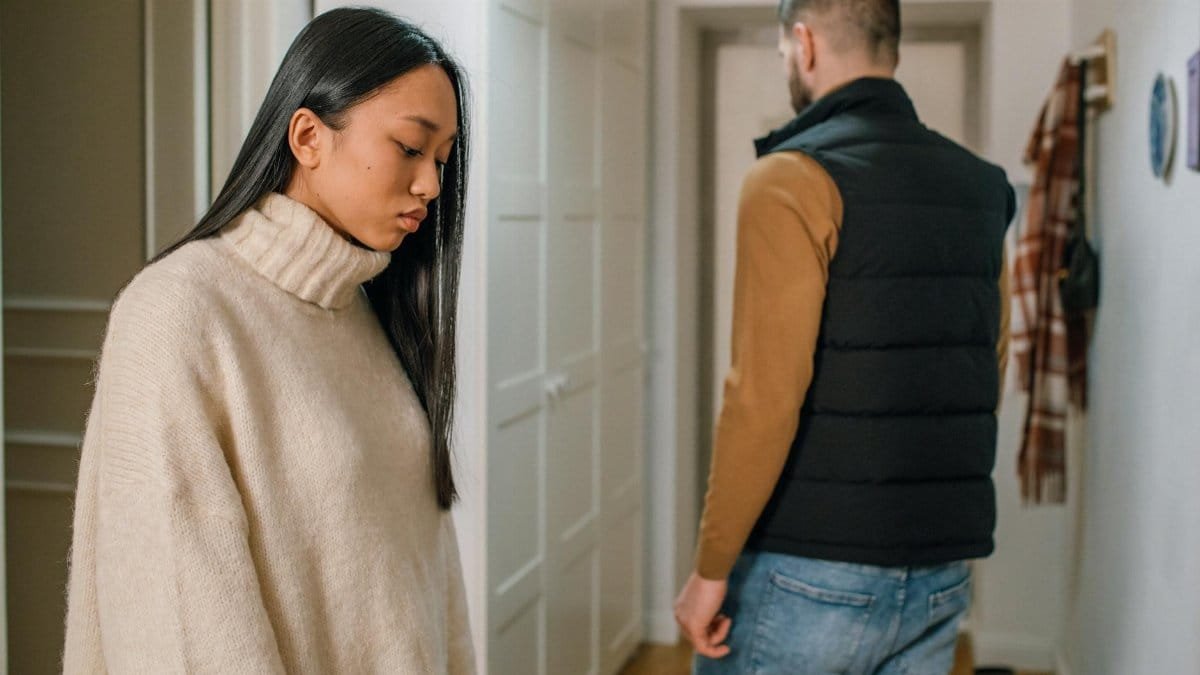 A couple experiencing relationship issues in a hallway, conveying emotional tension.
