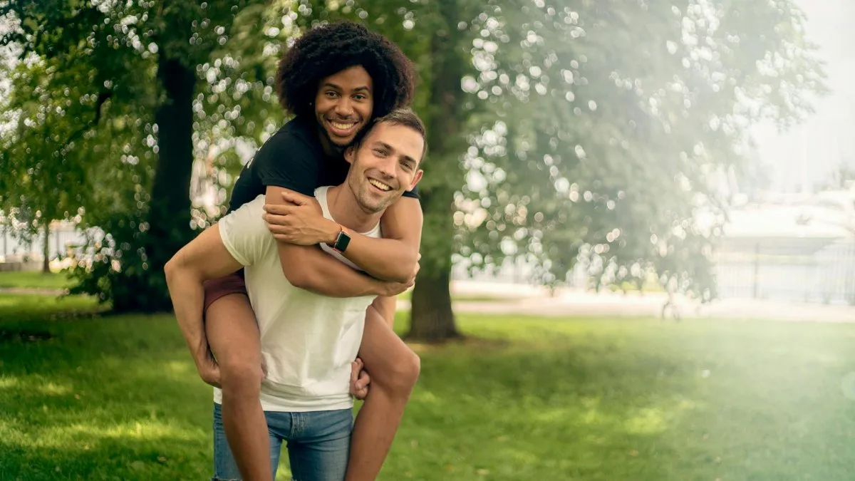 Smiling couple enjoying a playful moment outdoors in a Chicago park.