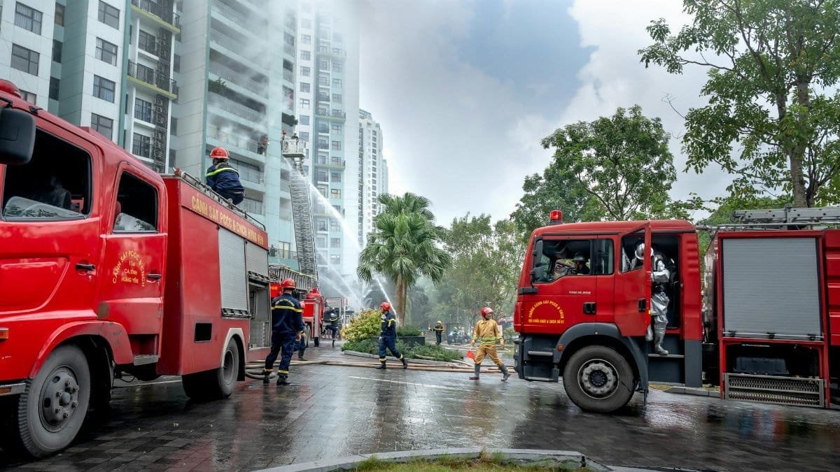 Emergency response with firefighters tackling a residential building fire in urban setting.