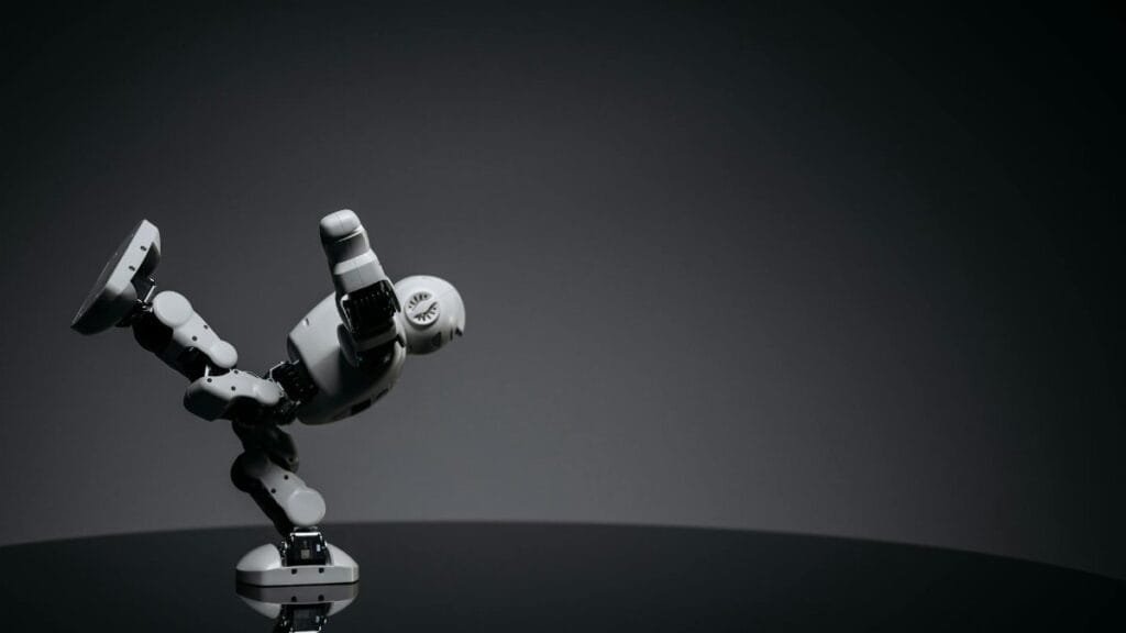 Minimalist photo of a toy robot balancing creatively in a studio setting.