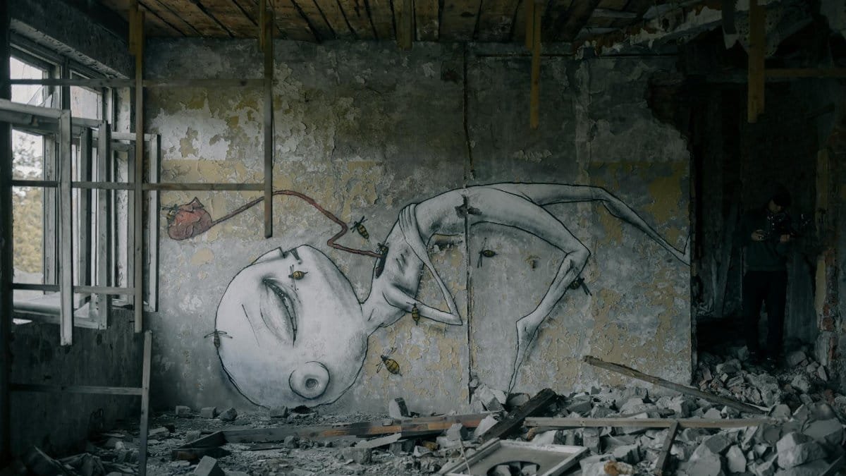 A decaying room featuring surreal graffiti art amidst rubble, capturing urban desolation and decay.
