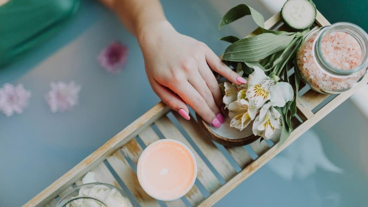 Elegant spa setting with flowers, bath salts, and calming ambiance for ultimate relaxation.