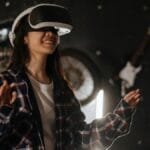 Young woman immersed in virtual reality using a VR headset, enjoying a digital world indoors.