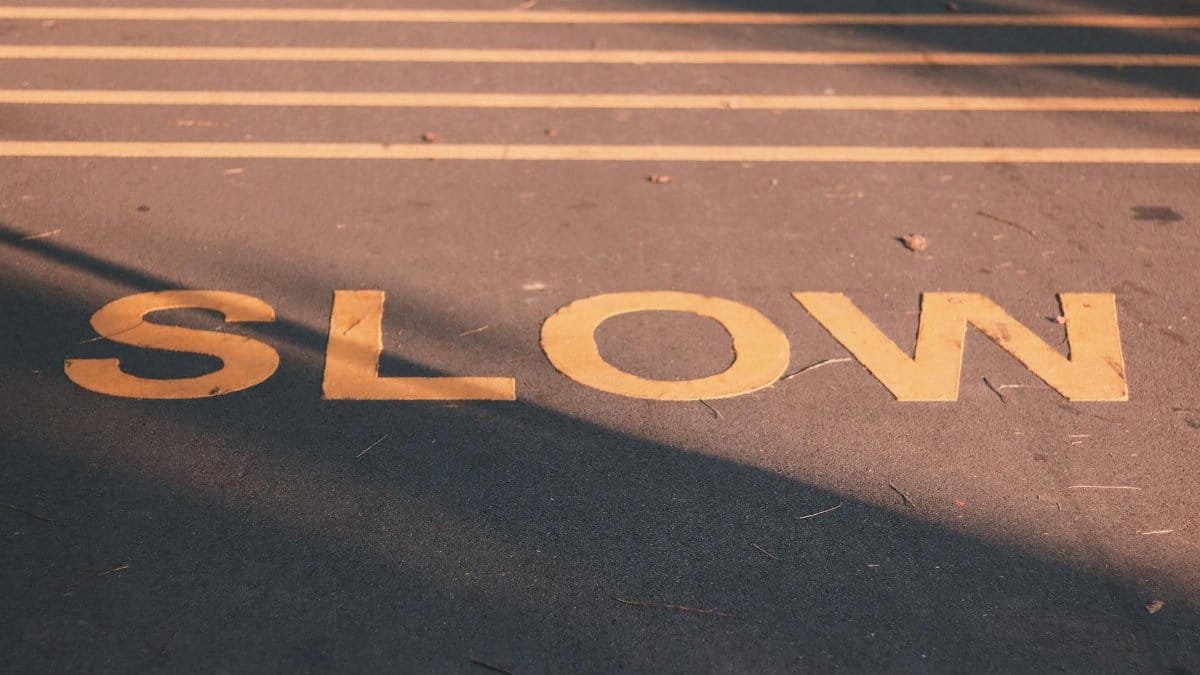 Close-up of a road with a slow sign in yellow, capturing a calm street scene in Singapore.