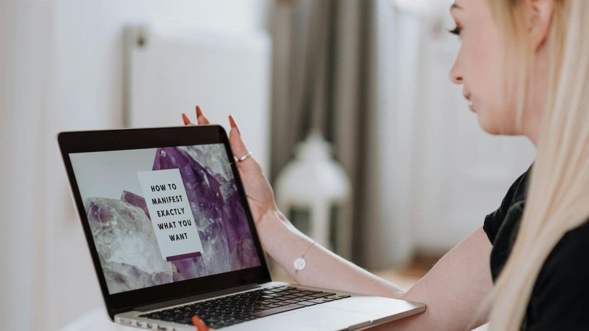 Woman engaging in an online manifestation course, focused and inspired.