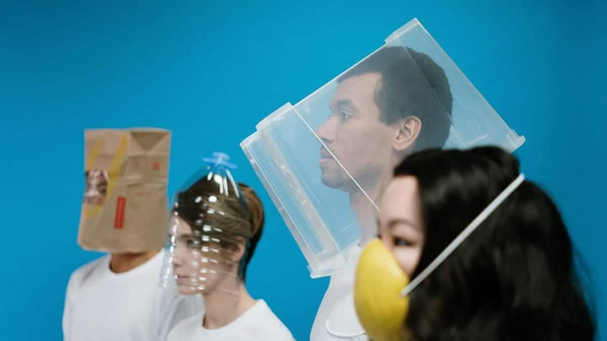 People wearing innovative DIY protection masks during a pandemic, showcasing unique creativity.