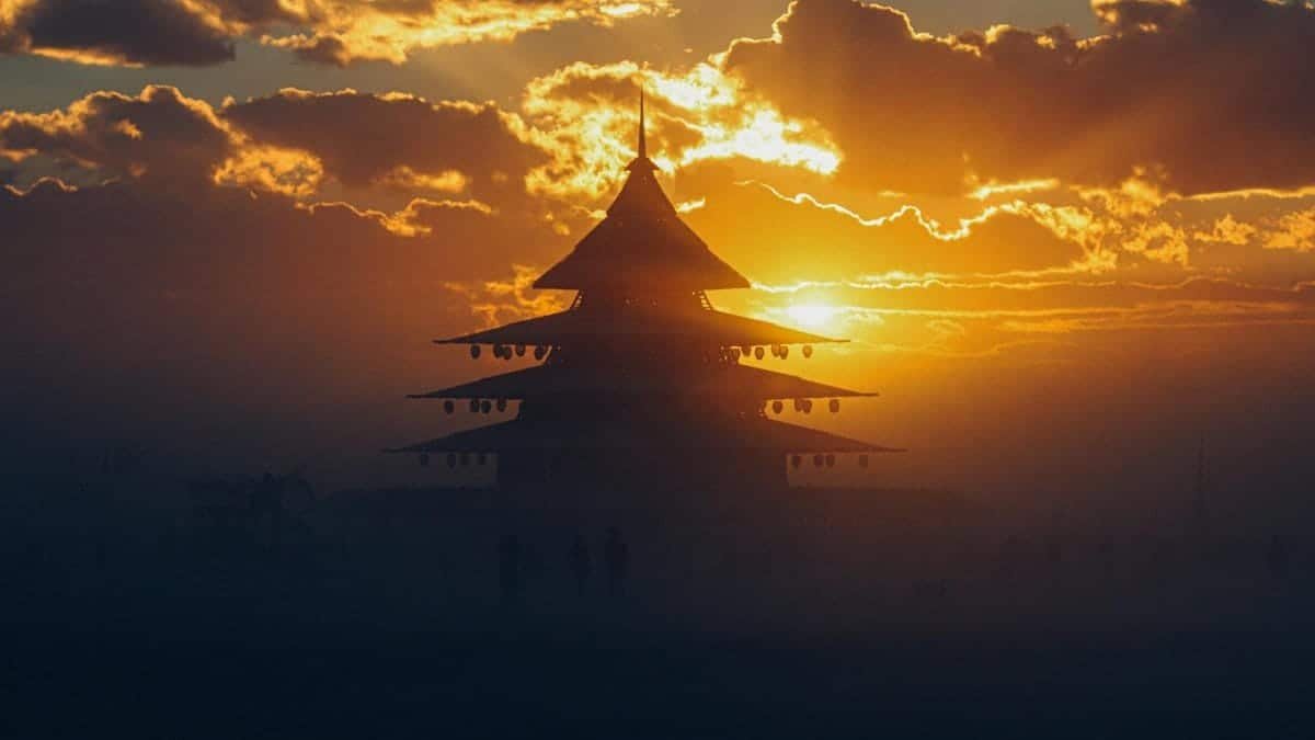 Dramatic silhouette of a pagoda during sunset at Burning Man festival, Nevada.