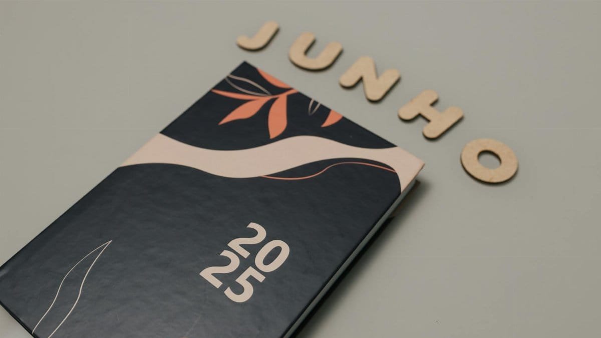 A sleek 2025 planner with a modern design sits beneath cutout letters spelling 'Junho'. Perfect for organizing and planning.