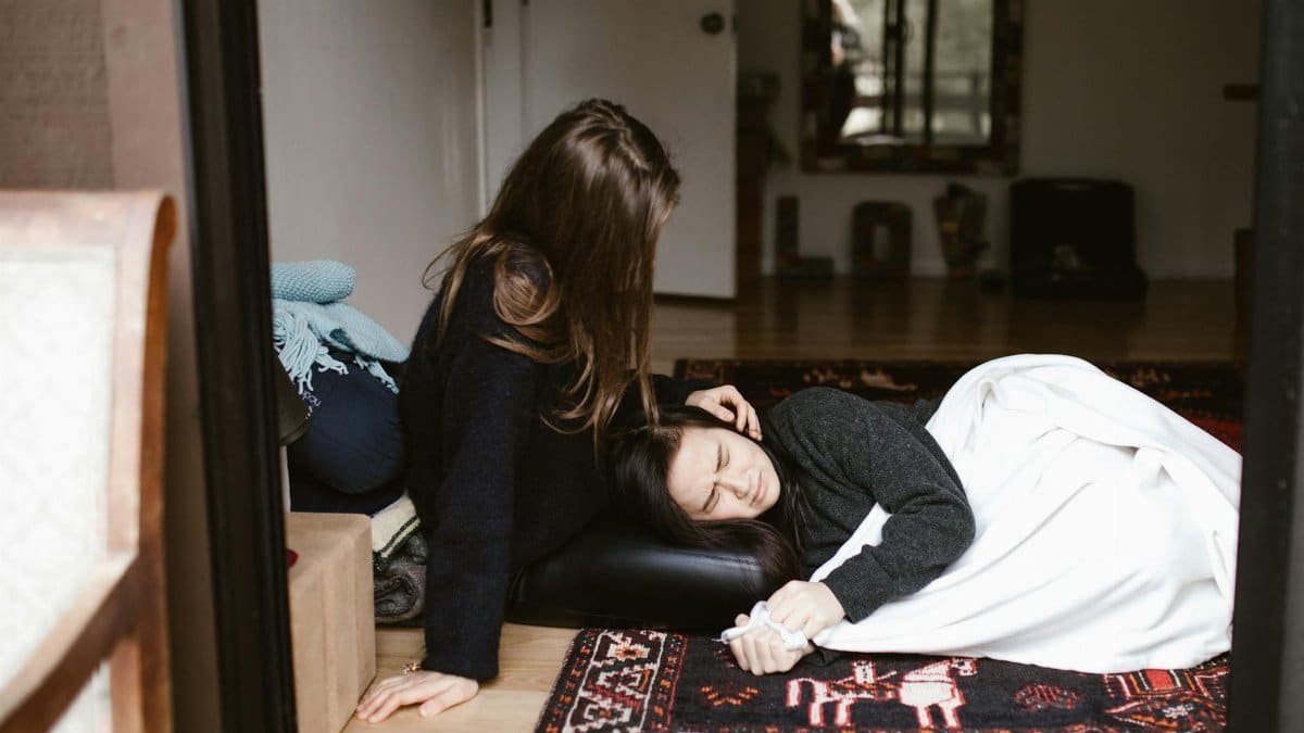 A woman comforts another during an emotional moment indoors, evoking themes of empathy and support.