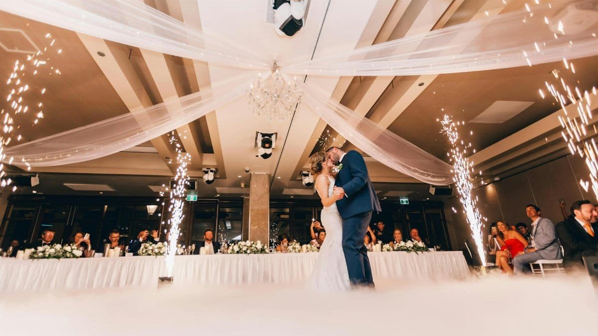 Romantic bride and groom dance surrounded by sparklers at a luxurious Sydney wedding reception.
