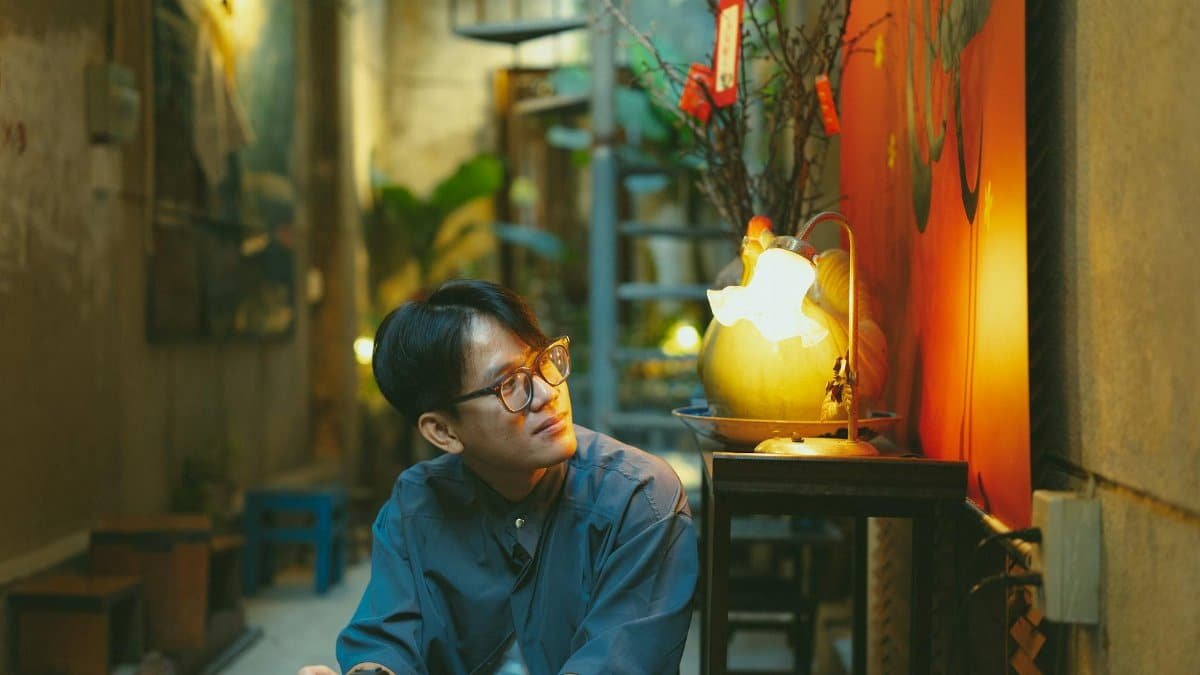 A man with a camera reflects in a vibrant alleyway, Vietnam's Ho Chi Minh City.