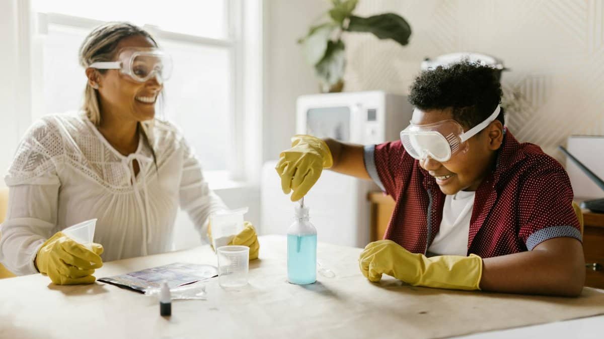 A mother and son engaged in a fun and educational science experiment at home, fostering quality family time.