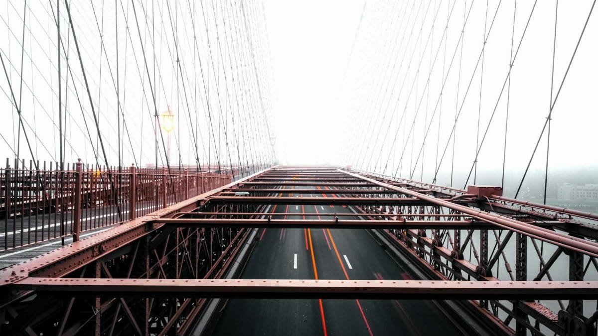 Striking image of Brooklyn Bridge with leading lines and foggy background.