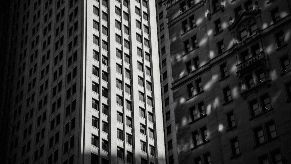 A striking black and white image of towering urban skyscrapers in a cityscape.