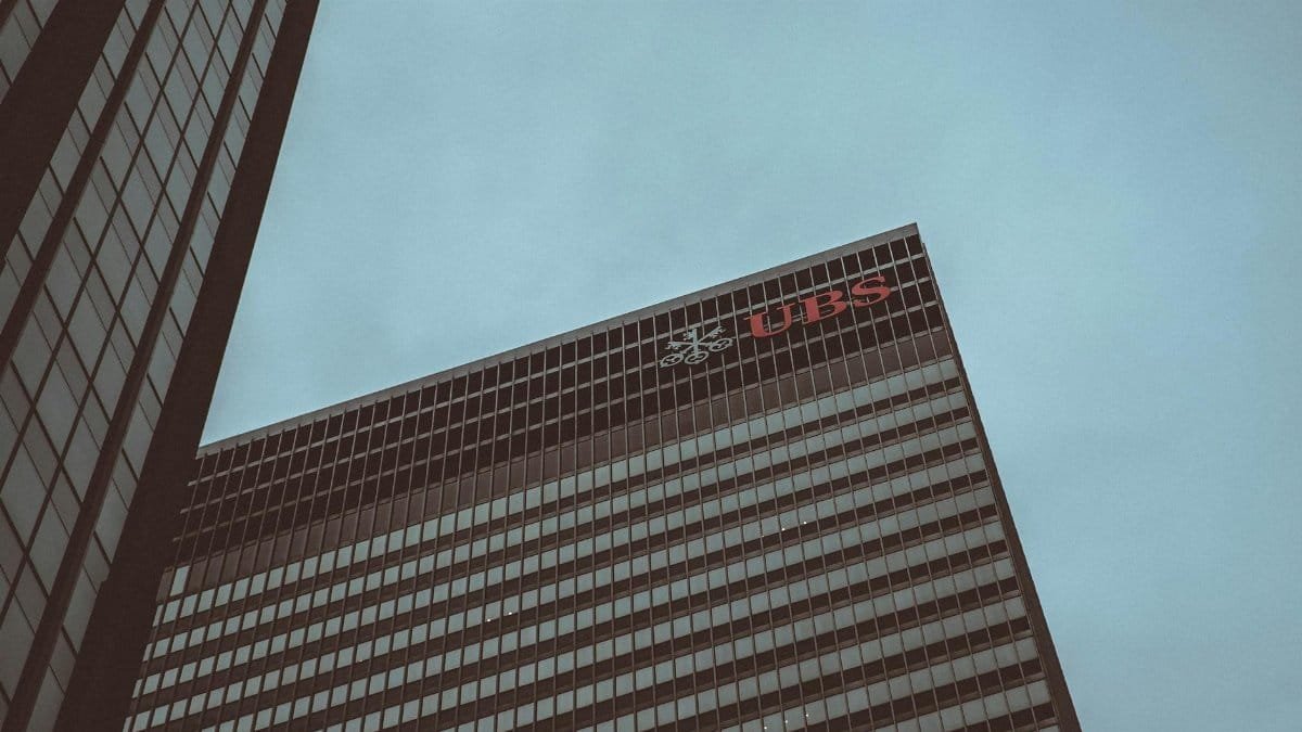 Modern skyscraper featuring the UBS logo against a clear sky in New York City.
