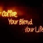 Glowing neon sign saying 'Your Coffee, Your Blend, Your Lifestyle' in warm tones, perfect for cafes.