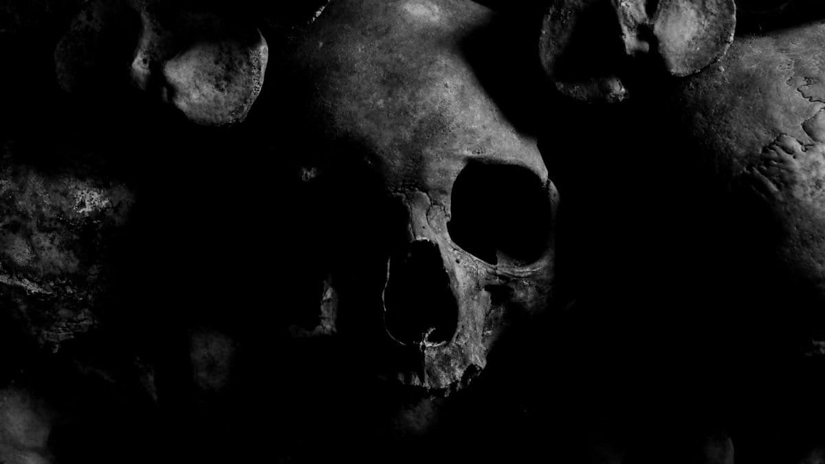 Dark eerie skull image with a moody atmosphere from the Paris Catacombs.