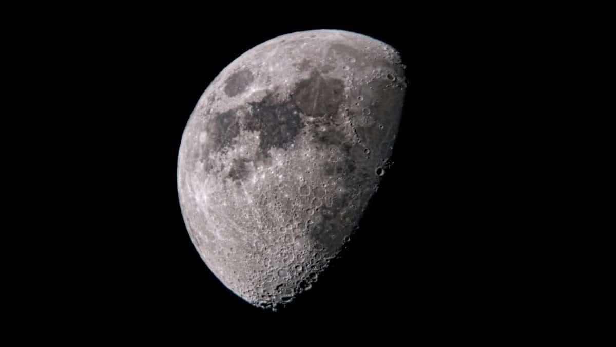 Close-up of the moon showcasing detailed lunar craters and texture against a black sky.