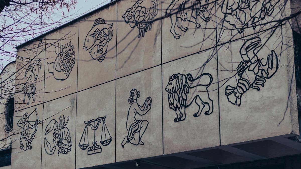 Outdoor mural depicting zodiac signs on a building wall in Chrzanow, Poland.