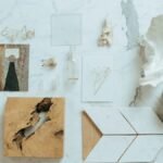 Minimalistic flat lay featuring diverse items on a marble background, showcasing natural textures.