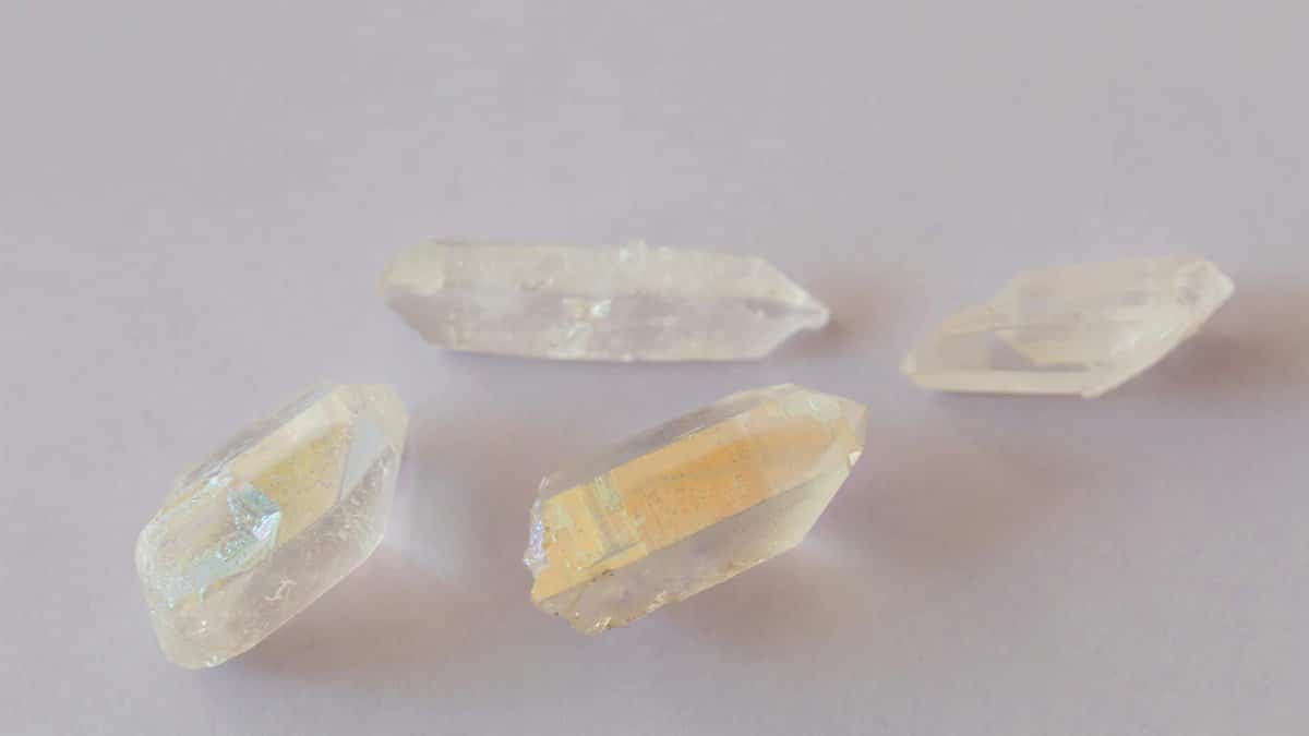 Elegant translucent quartz crystals displayed on a pale surface, highlighting texture and clarity.