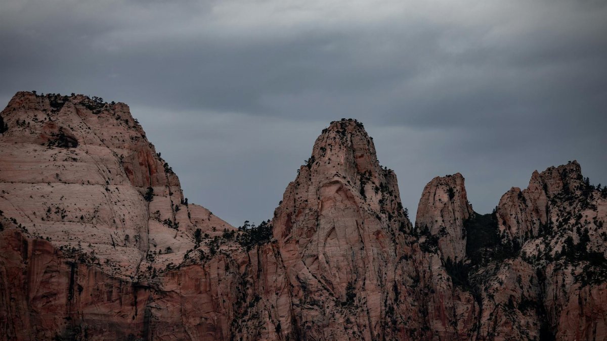Towering rocky peaks under a moody sky at Zion National Park, Utah.