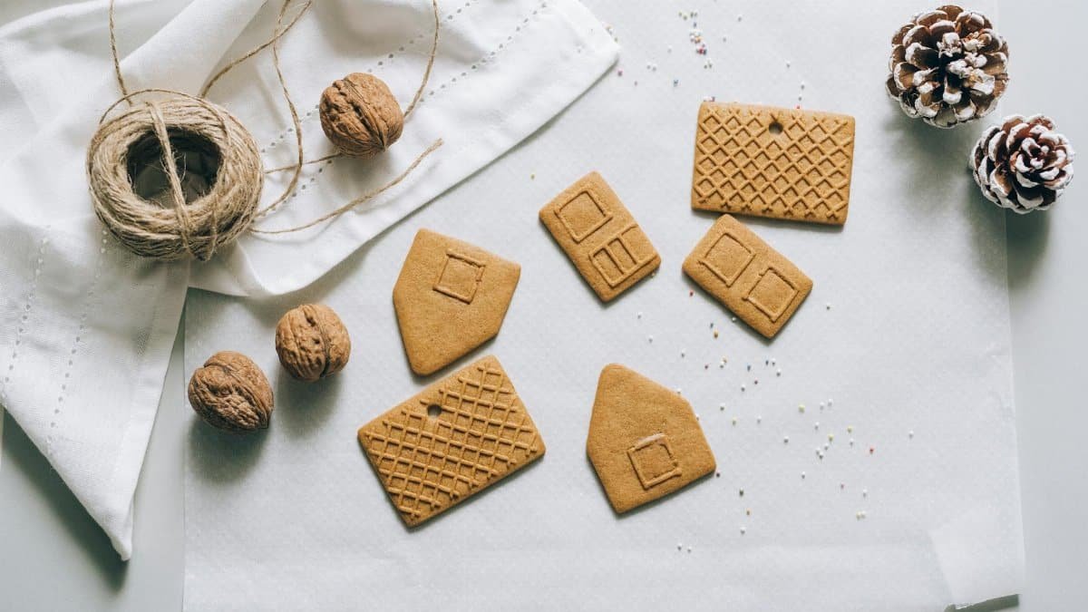 Various gingerbread pieces ready for assembly into a festive house, perfect for holiday baking.