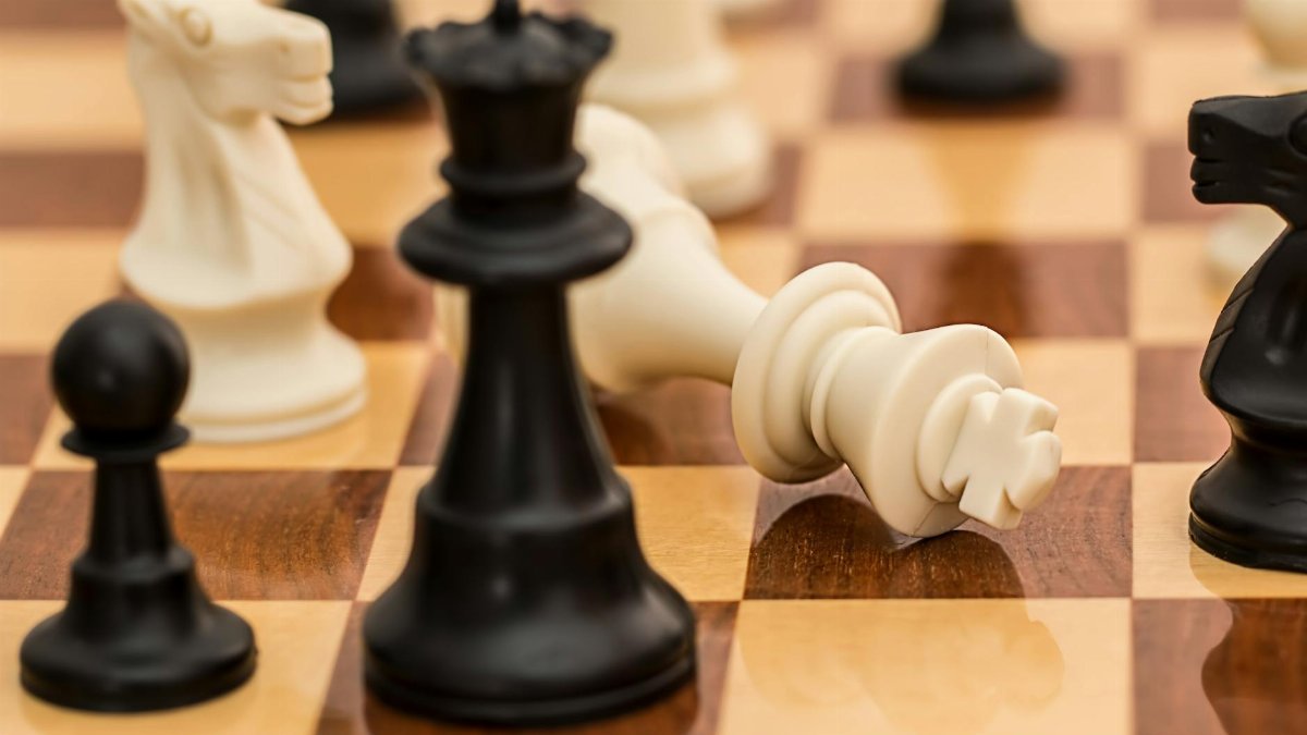 Close-up of chess pieces on a board depicting strategy and challenge.