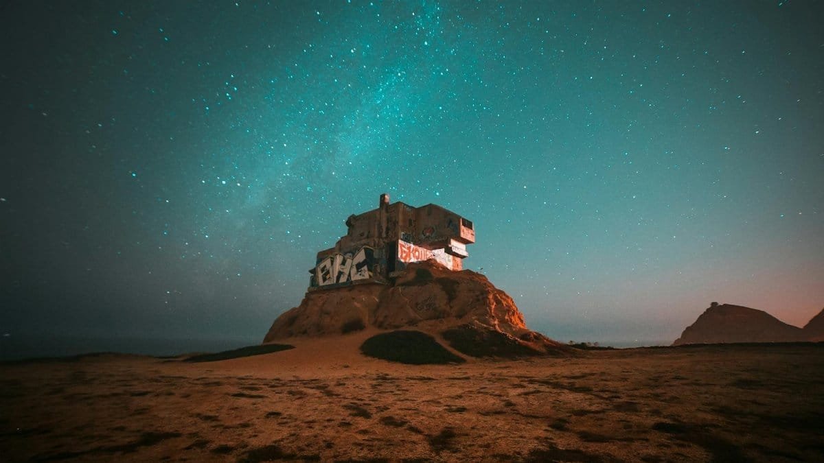 Abandoned structure in Pacifica, CA, under a starry night sky, capturing the serenity and mystery of the Milky Way.
