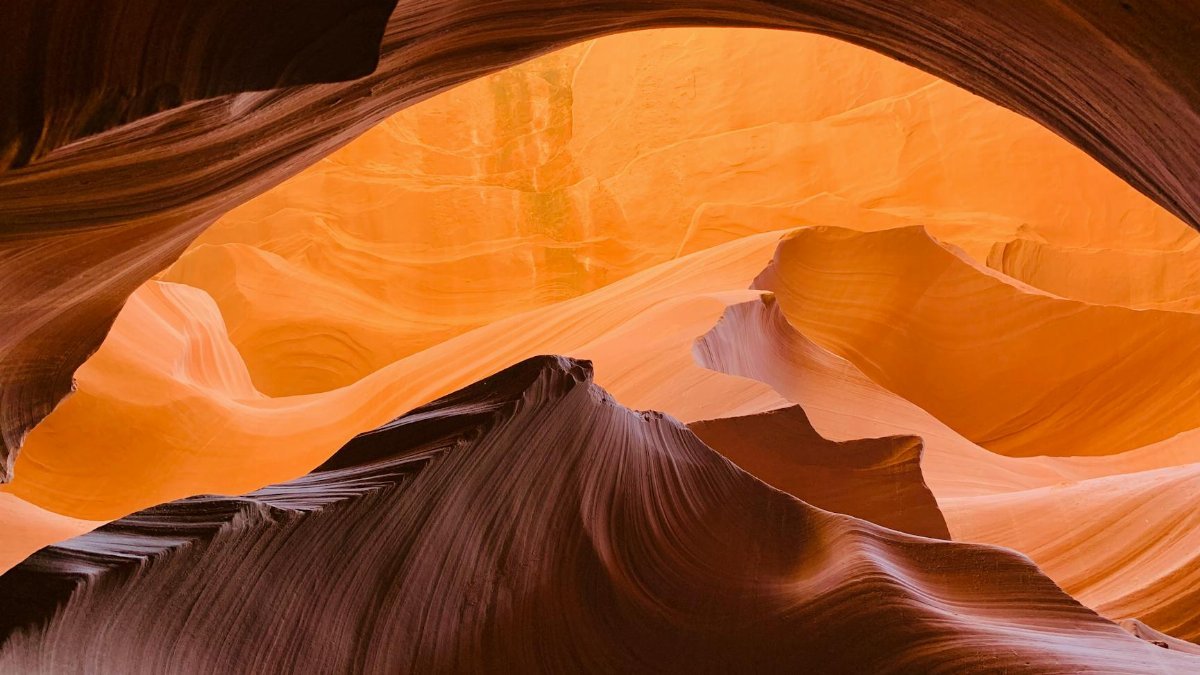 Explore the stunning sandstone formations of Antelope Canyon, Arizona, captured in warm hues and natural light.