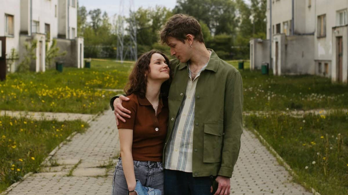 A young couple in a loving embrace on a spring day in an urban park.