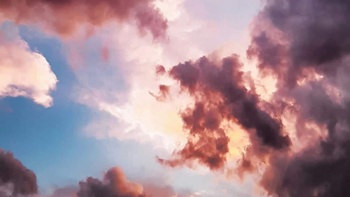 A vibrant and dreamy sky with pink and orange clouds during a sunset, showcasing nature's beauty.