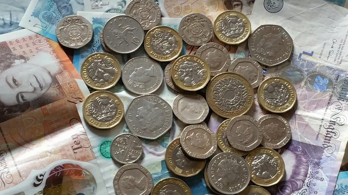 A detailed image of British Pound Sterling coins and banknotes, perfect for finance-related projects.