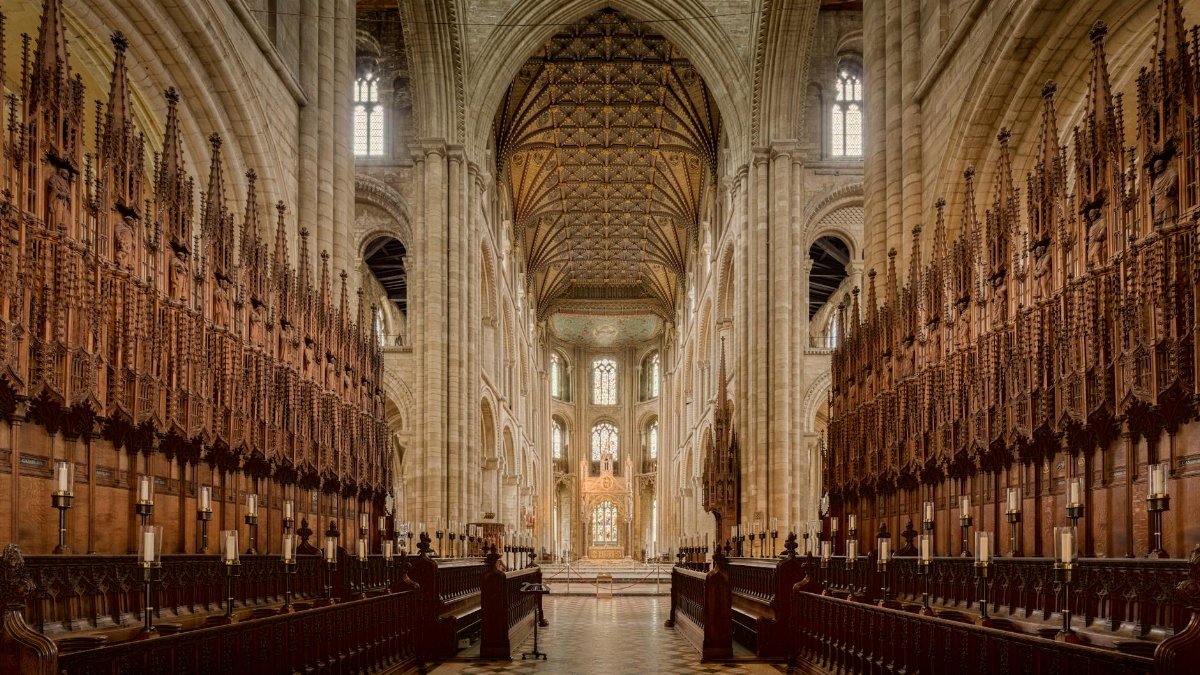 Explore the majestic Gothic architecture of Peterborough Cathedral's interior.