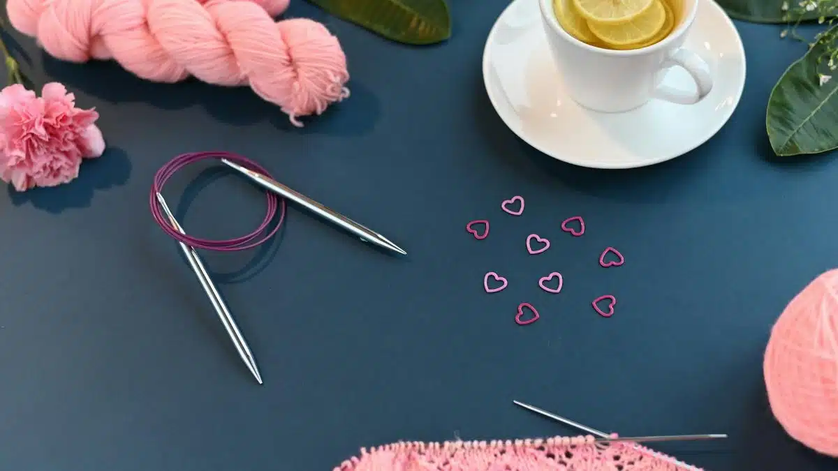 Artistic flat lay of knitting necessities with lemon tea for a relaxing vibe.