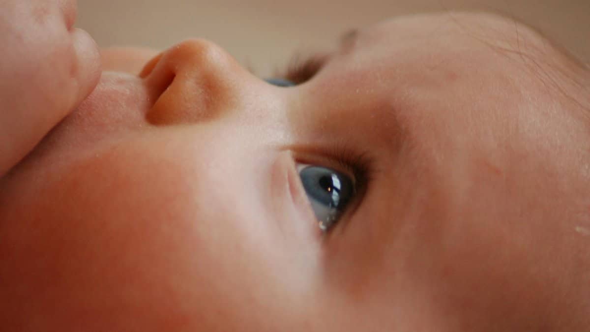 A heartwarming close-up of a baby's face showcasing innocent eyes with a soft, gentle expression.